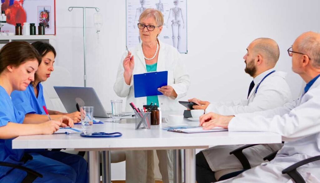 Doctors and nurses discussing research at a meeting