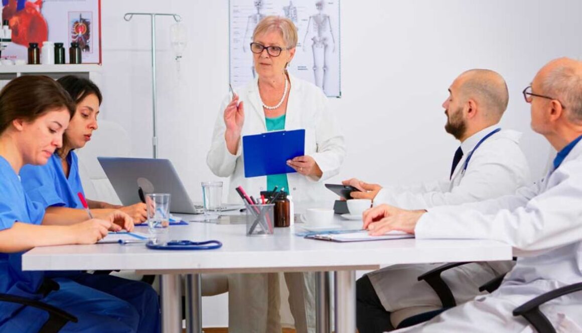 Doctors and nurses discussing research at a meeting
