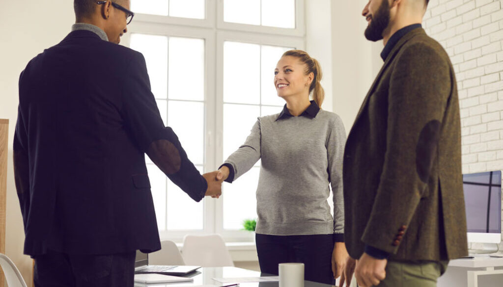 Team in office shaking hands