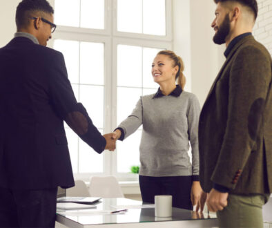 Team in office shaking hands