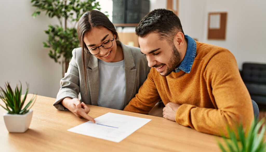 Man and woman looking at paper smiling