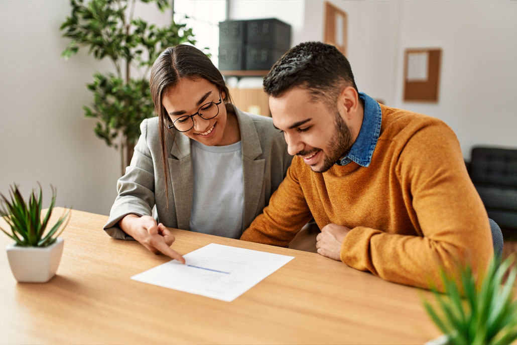 Man and woman looking at paper smiling