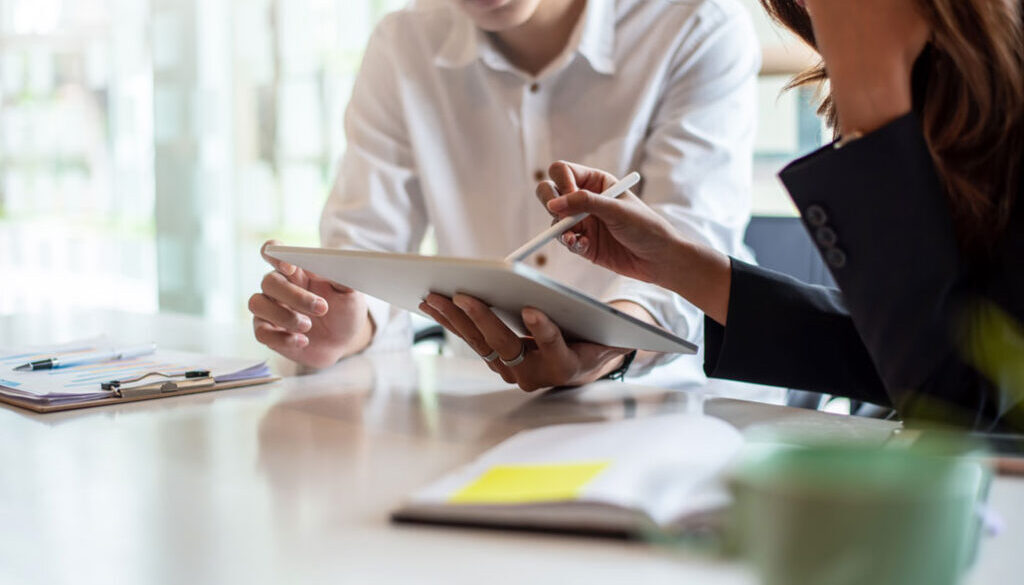 Two people working on tablet