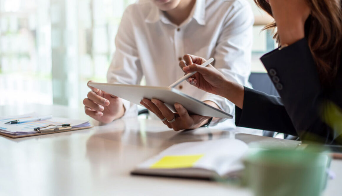 Two people working on tablet