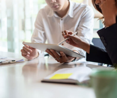 Two people working on tablet