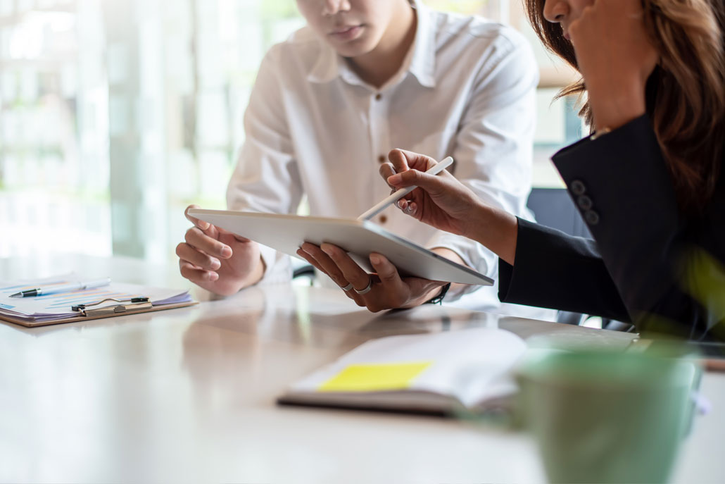 Two people working on tablet