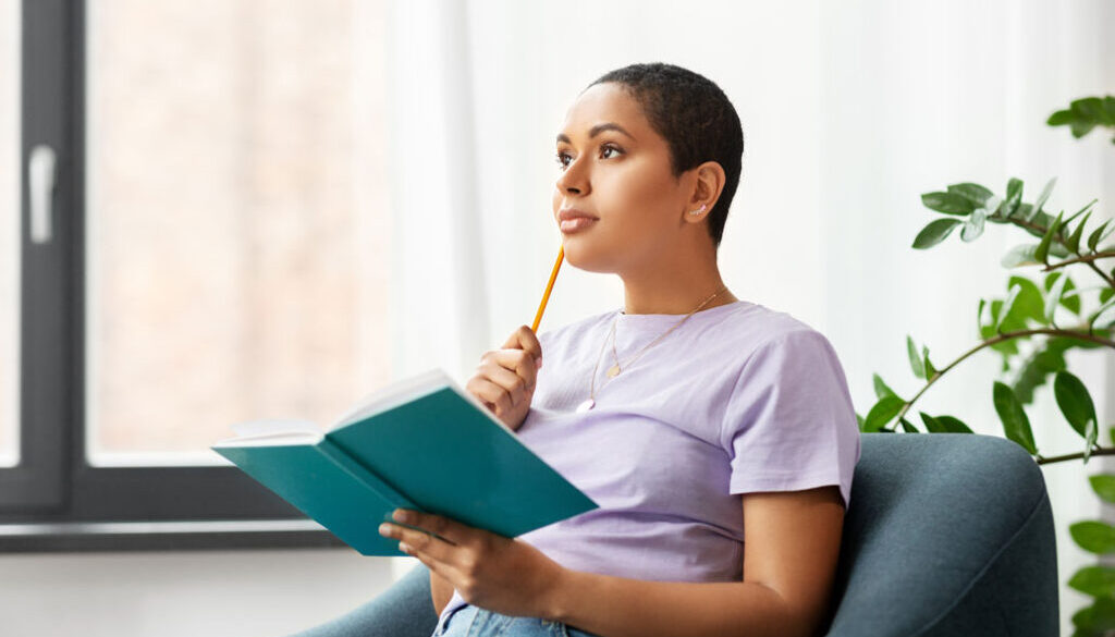 Woman with pencil and notebook thinking